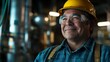 © kevin - Smiling Hispanic Worker in Safety Gear: Professional Portrait in Industrial Setting. Factory Employee with Hardhat and Protective Eyewear Showcasing Workplace Safety and Labor Day Themes.