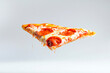 © Hunman - Flying Pepperoni pizza slice, cheese, white background.