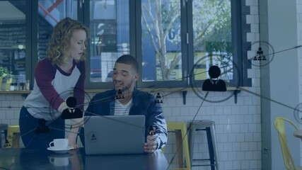 Wall Mural - Animation of network of connections with icons over diverse colleagues discussing work in office