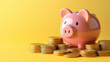 © Katrin_Primak - cheerful pink piggy bank next to several gold coins. Investment accumulation, financial concept