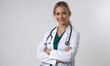 © Miklos - A female doctor stands with her arms crossed, smiling at the camera, in a white coat