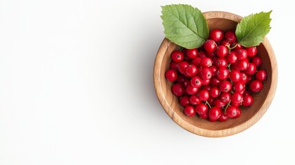 A top-down view of a wooden bowl filled with ripe red viburnum berries, adorned with two green leaves. The berries are vibrant and fresh, symbolizing nature's bounty, health