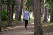 © Edijs - Woman in a wite suit with Nordic walking sticks. In a beautiful sunny autumn park. Healthy lifestyle.