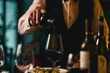 © alisaaa - Close-up of sommelier serving red wine at fine dining restaurant Close-up of waiter holding bottle and serving red wine during dinner at luxurious gourmet restaurant
