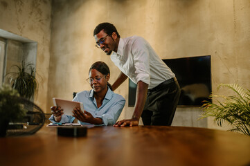 African american business colleagues working together on a tablet at the office