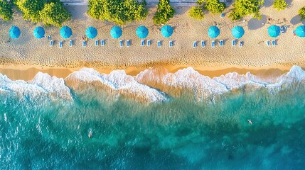 Wall Mural -   A bird's-eye view of a sandy beach with blue umbrellas and trees on either side