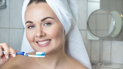 Close-up photo. Young beautiful woman holding toothbrush. 