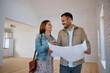 © Drazen - Happy couple analyzing blueprints while buying  new house.