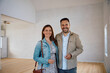 © Drazen - Happy couple buying new house and looking at camera.