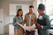 © Drazen - Happy man and his wife examining housing plans with their real estate agent during open house day.