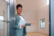 © Drazen - Happy African American real estate agent welcoming her clients and looking at camera. Copy space.