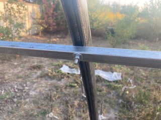 Installation of a metal frame greenhouse with polycarbonate covering