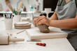 © Rabizo Anatolii - Removing air bubbles from clay before modeling to avoid the ruination of a ceramic product. Wedging the clay before starting making a pottery project to create proper consistency.