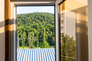 Wall Mural - roof and green mountain in open window in Dilijan