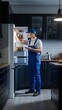 © Wix - Male technician in uniform reprs a broken refrigerator in the kitchen