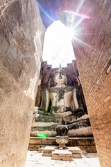 Wall Mural - The background of one of the important tourist attractions in Sukhothai Historical Park, Wat Si Chum, has a large Buddha statue that is hundreds of years old for tourists to learn about its history.