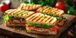© TheWaterMeloonProjec - Freshly made club sandwiches showcased on a wooden table.