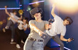 © JackF - Excited girl in business suit having fun with her friends in virtual reality room