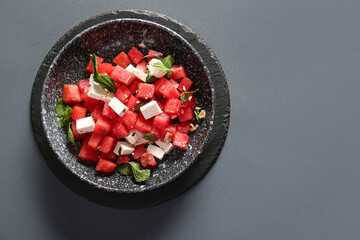 Canvas Print - Bowl of tasty watermelon salad on grey background