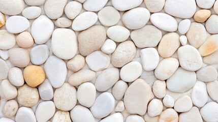 A collection of smooth white pebbles arranged closely together offers a serene and elegant appearance, ideal for decorative use