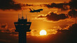 © Creativision - Silhouette of an airplane flying over the control tower at sunset