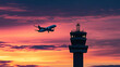 © Creativision - Silhouette of an airplane flying over the control tower at sunset