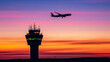 © Creativision - Silhouette of an airplane flying over the control tower at sunset