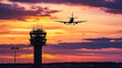 © Creativision - Silhouette of an airplane flying over the control tower at sunset