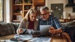 © Oulaphone - Senior couple reviewing their savings plan after retirement together, saving concept.