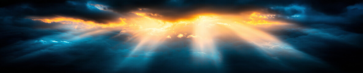 Wall Mural - a beautiful blue sky with sun rays illuminating the clouds from behind.