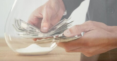 Poster - Animation of caucasian man counting banknotes over hourglass