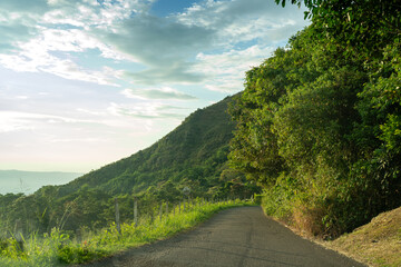 Wall Mural - Secondary rural road between mountains in tropical area