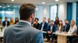 © VistaVisions - Confident businessman giving a presentation in front of crowd in meeting conference seminar room. Leadership authority teamwork in business concept