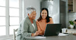 © PeakPoints/peopleimages.com - Home, mother and daughter with laptop for budget, track expenses and success for financial goals. Kitchen, senior mom and happy woman with tax review for retirement, insurance savings and mortgage