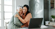© peopleimages.com - Home, mother and woman with laptop for finance, track expenses and success for budget goals. Hug, senior mom and adult daughter with insurance review for retirement, investment savings and mortgage