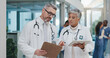 © peopleimages.com - Advice, discussion and doctors in hospital with clipboard, tablet or meeting for schedule in lobby. Results, man and woman together in healthcare with paperwork, consulting and medical team in clinic