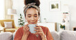 © peopleimages.com - Woman, happy and smell coffee on sofa with thinking, reflection and start morning in home. Girl, person and tea cup with memory, insight and drink with nostalgia on living room couch at apartment