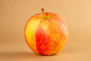 One red apple on kraft paper, macro.