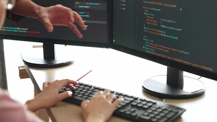 Slow motion back end or software developer manager supervising his team on new application program development on debugging and solving complex code algorithms on monitor. Burgeoning
