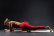 © st.kolesnikov - Sporty woman doing body massage with foam roller on mat on black background. Muscle relaxation. Concept of sporty lifestyle, beauty, body and health, fitness