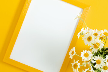 Sticker - Flowers and frame on yellow table. Blank frame for text, spring and summer chamomile white flowers on yellow background. Flat lay, top view, copy space 