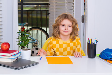 Fototapete - Nerd school kid writing homework at home. Clever child from elementary school with book. Smart genius intelligence kid ready to learn. Hard study.