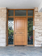 Poster - A classic design house entrance with a wooden door between glass openings. Travel to Athens, Greece.