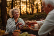 © bernardbodo - Older people eating grapes in the woods