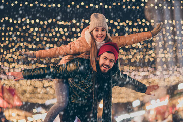 Sticker - Photo of couple having fun evening outside x-mas christmas event boyfriend hug piggyback girlfriend hold hands fly illumination newyear around fair