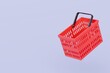© Theeraphat - 3D Red Shopping basket icon isolated on purple background. Online Shopping Concept, E-Commerce logistic delivery Concept. Minimal Empty red shopping basket plastic icon creative design. 3d render.
