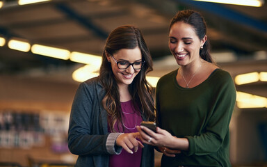 Canvas Print - Business people, typing and women in office, smartphone and social media with connection, texting and smile. Employees, mobile user and coworkers with cellphone, communication and message to contact