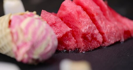 Wall Mural - watermelon and melon ice cream on the table, waffle cone with ice cream and pieces of melon and watermelon