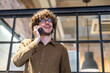 © Art_Photo - Young businessman talking on smartphone in modern office, professional communication corporate work, confident male entrepreneur, business discussion, workplace productivity, urban lifestyle