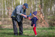© Светлана Лазаренко - Grandfather and grandson launch an airplane during a walk in the forest. Family having fun in nature. Playing with grandson.